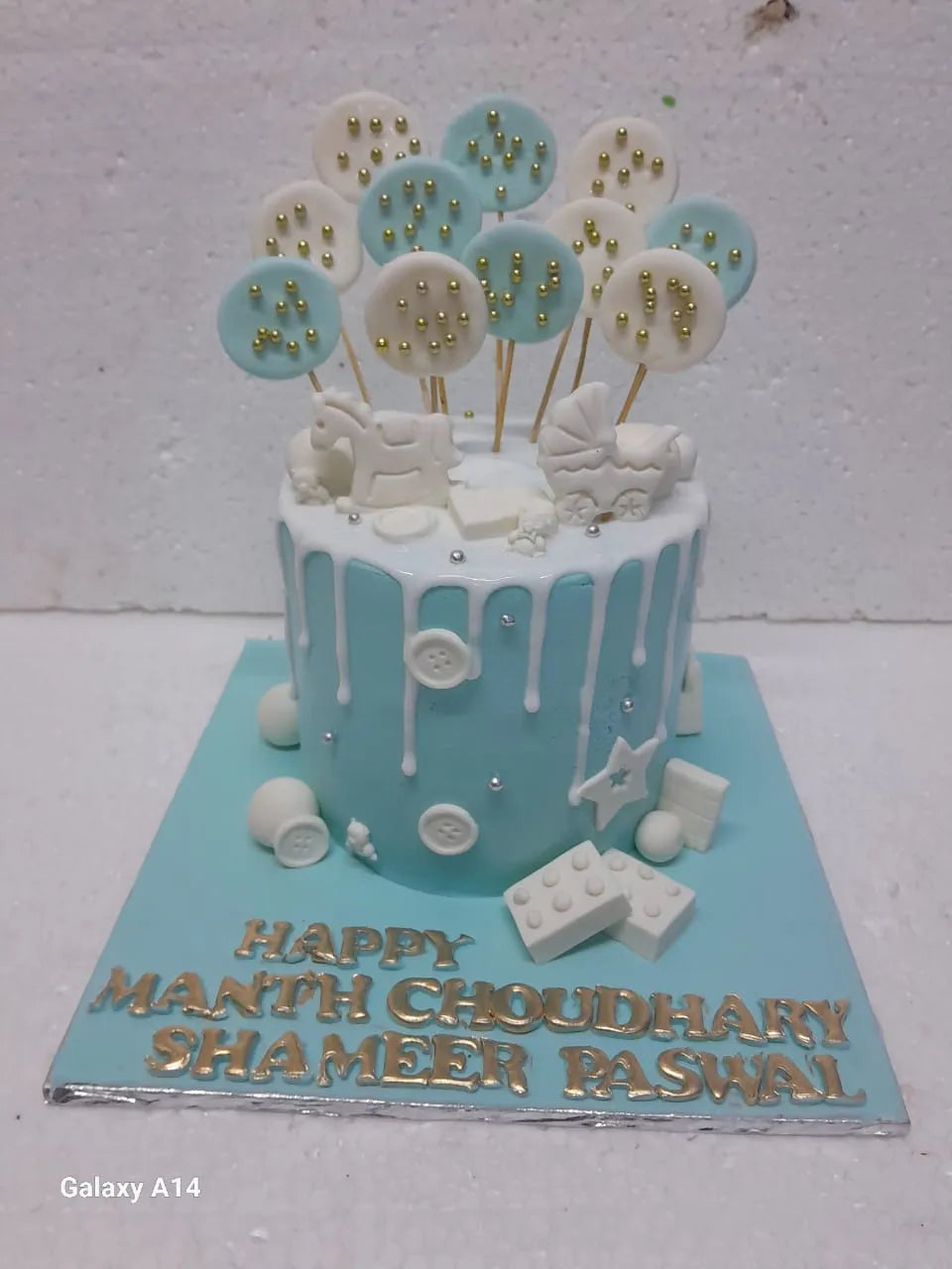 Baby-themed cake with decorative elements on a white background