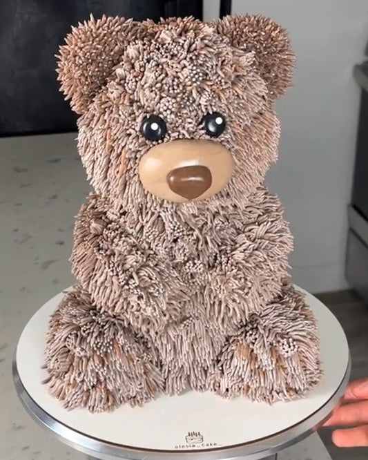 Plush teddy bear on a small round table with a blurred background