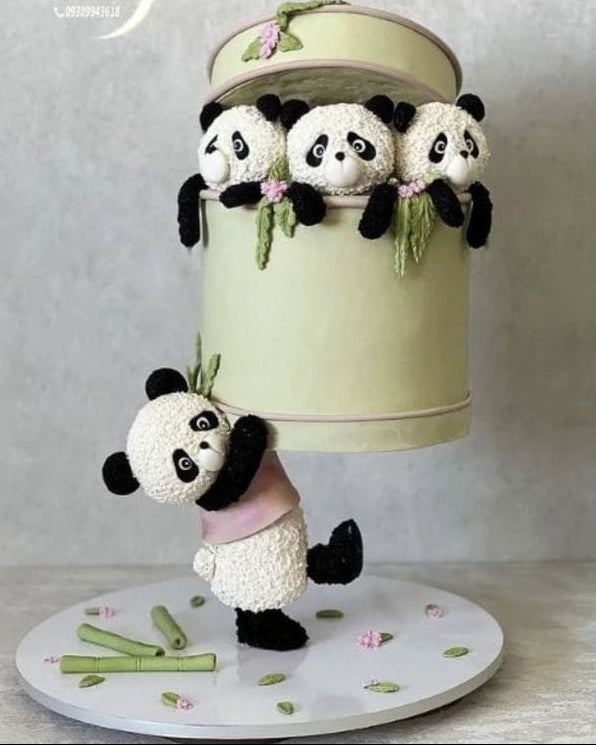 Decorative cake with panda design on a neutral background