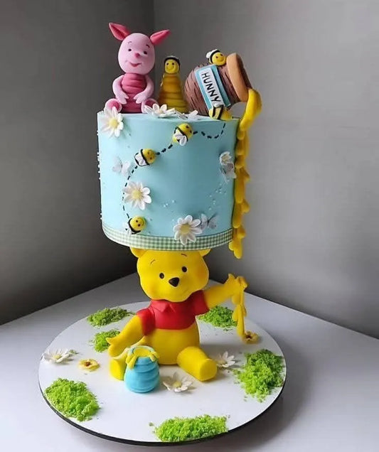 Cake decorated with Winnie the Pooh and friends on a gray background