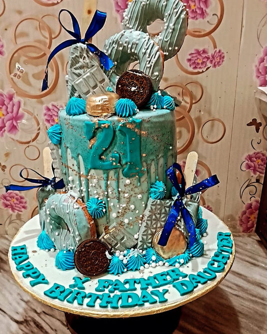 Decorative cake with teal and blue theme on a floral background