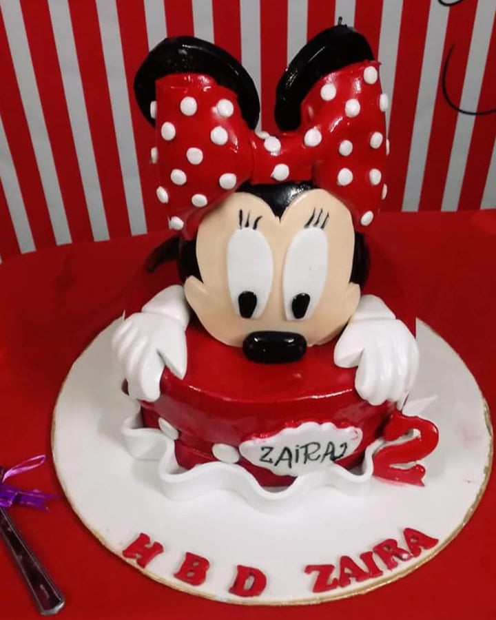 Red and white cake with cartoon character on a red surface