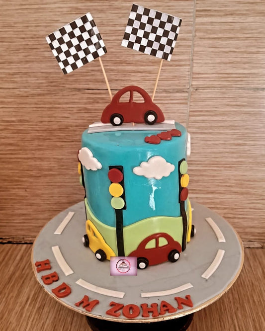 Children's birthday cake with traffic light and car design on a wooden surface